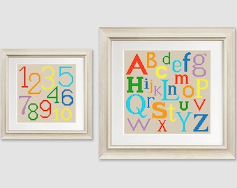 May include: Two framed cross-stitch pieces, one with the alphabet in rainbow colors and the other with the numbers 1-10 in rainbow colors.