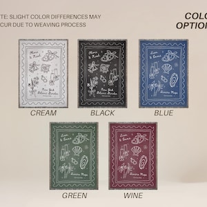 May include: Five rectangular throw blankets in cream, black, blue, green, and wine colors. Each blanket features a white sketched design with text, including names and "New York Botanic Garden" or "Rimers Maps". The blankets are displayed with the color options labeled.
