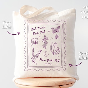 May include: Cream-colored tote bag with a purple stamp-like design. The design includes illustrations of a book, sword, butterflies, and flowers. Text on the bag reads "Club Name Book Club, New York, NY, Est. 2025".