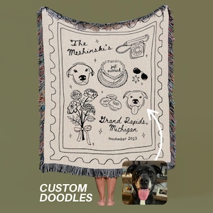 May include: Cream-colored woven blanket with black doodle illustrations. Features a telephone, cake, dog portraits, flowers, and text that reads "The Meshinski's", "Grand Rapids, Michigan, November 2023", and "just married". The bottom reads "CUSTOM DOODLES".