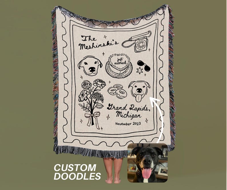 May include: Cream-colored woven blanket with black doodle illustrations. Features a telephone, cake, dog portraits, flowers, and text that reads "The Meshinski's", "Grand Rapids, Michigan, November 2023", and "just married". The bottom reads "CUSTOM DOODLES".