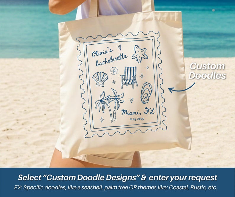 May include: Cream-colored tote bag with a blue doodle design. The design includes a seashell, starfish, beach chair, palm trees, and the text "Olivia's bachelorette" and "Miami, FL July 2025". The bag has a rectangular shape.