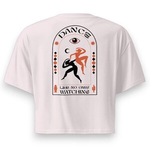 May include: White t-shirt with a graphic design on the back. The design features two stylized dancers, one black and one orange, within an arched frame. The words "DANCE" and "LIKE NO ONES WATCHING" are also included.
