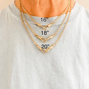 May include: Three gold chains with a hook clasp, shown on a model wearing a light blue shirt. The chains are 16 inches, 18 inches, and 20 inches long.