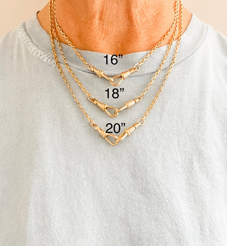 May include: Three gold chains with a hook clasp, shown on a model wearing a light blue shirt. The chains are 16 inches, 18 inches, and 20 inches long.
