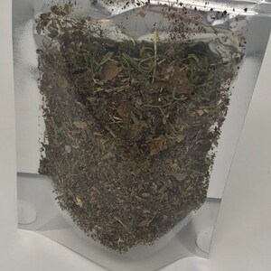 May include: A clear plastic bag filled with a mixture of dried herbs and leaves. The herbs are a mix of brown, green, and tan.