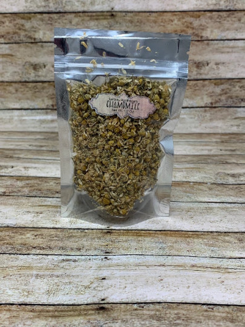 May include: A silver resealable pouch filled with dried chamomile flowers. The pouch has a label that reads "Loose Chamomile" and "Net Wt. 1 oz."