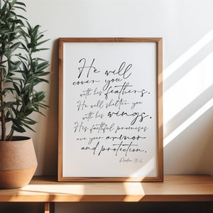 May include: A framed print with a white background and black text. The text reads "He will cover you with his feathers. He will shelter you with his wings. His faithful promises are your armor and protection. Psalm 91:4".