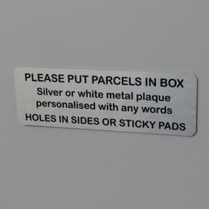 May include: A silver or white metal plaque with the text "PLEASE PUT PARCELS IN BOX", "Silver or white metal plaque personalised with any words", and "HOLES IN SIDES OR STICKY PADS".