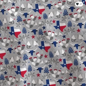 May include: A gray fabric with a repeating pattern of Texas-themed illustrations. The design includes the Texas state flag, armadillos, longhorn steer skulls, bluebonnet flowers, cacti, and red and blue stars.