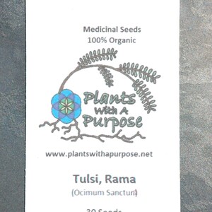 May include: A white packet of Tulsi, Rama (Ocimum Sanctum) seeds. The packet has a logo with a blue flower and the text "Plants with a Purpose" and the website address "www.plantswithapurpose.net". The packet contains 30 seeds.