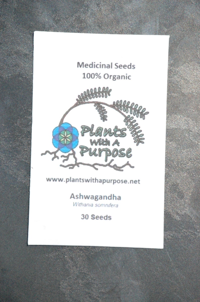 Puede incluir: Un sobre blanco de "Semillas Medicinales" con el texto "100% Org&aacute;nico" y un logotipo que dice "Plants With A Purpose". El sobre tambi&eacute;n enumera "Ashwagandha" y "30 Semillas".