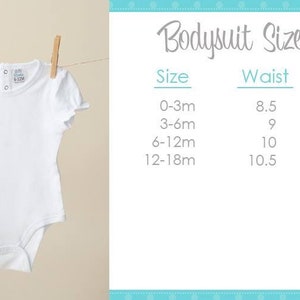 May include: A white baby bodysuit with short, ruffled sleeves, hanging from a clothesline with wooden clothespins. The bodysuit has a round neckline and snap closures. A "Bodysuit Size Chart" is displayed, showing measurements for different sizes.