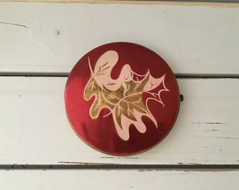Vintage metal powder compact in red and gold embellished with leaf/Bedroom prop