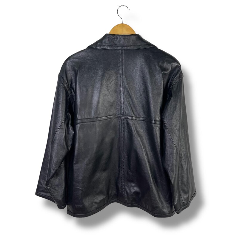 May include: A black leather jacket with a zipper closure and a collar. The jacket has a seam down the center of the back and a seam across the shoulders.