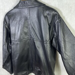 May include: A black leather jacket with a zipper closure and a stand-up collar.
