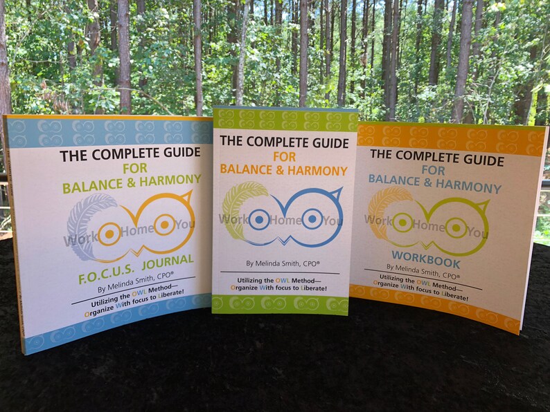 May include: Three colorful guide books with the title "The Complete Guide for Balance & Harmony" and the logo "Work Home You". The first book is titled "F.O.C.U.S. Journal", the second is titled "Utilizing the OWL Method", and the third is titled "Workbook". All three books are by Melinda Smith, CPO.