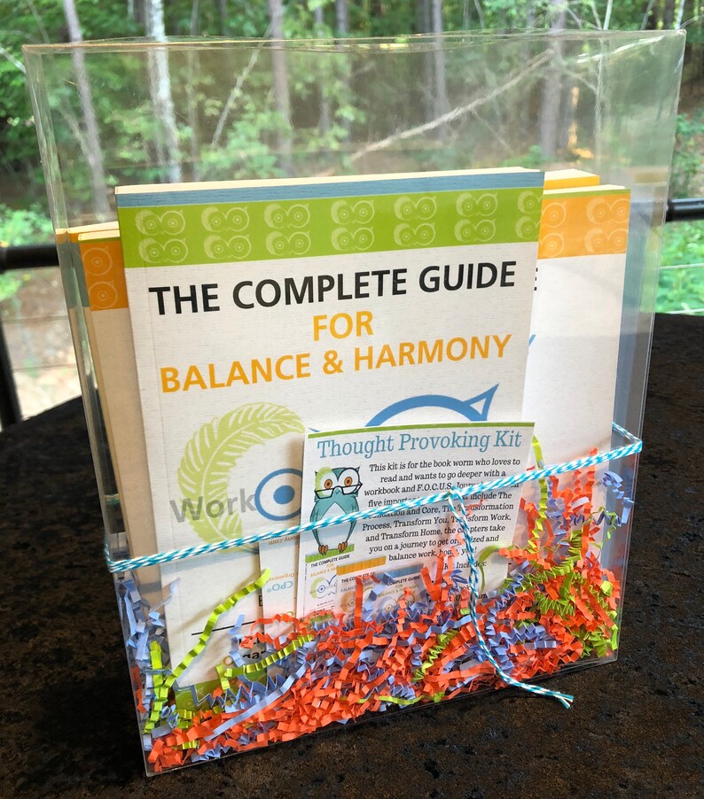 May include: A clear plastic box filled with colorful shredded paper and a book titled "The Complete Guide for Balance & Harmony". A smaller card with the title "Thought Provoking Kit" is visible. The kit includes a workbook and a guide to help readers focus and transform their lives.