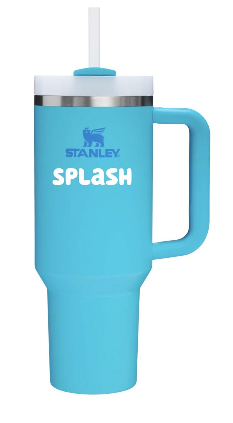 May include: A bright turquoise Stanley tumbler with a large side handle, a white lid, and a clear straw. The word "SPLASH" is printed in white letters on the front, positioned below the blue Stanley logo featuring a winged bear emblem.