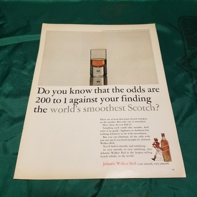 May include: A vintage advertisement for Johnnie Walker Red Scotch whisky. The ad features a glass of scotch and the text "Do you know that the odds are 200 to 1 against your finding the world's smoothest Scotch?"  The ad also features a man in a kilt walking with a bottle of Johnnie Walker Red Scotch whisky.