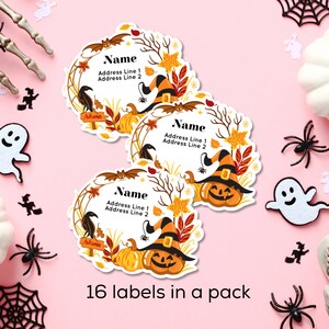 May include: Halloween-themed labels with a pumpkin wearing a witch hat, surrounded by autumn leaves and the text "Name, Address Line 1, Address Line 2". The labels are decorated with spiders, ghosts, and cobwebs on a pink background.
