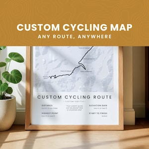 May include: Framed custom cycling map print with text "CUSTOM CYCLING MAP ANY ROUTE, ANYWHERE". The map shows a cycling route with points of interest. The print includes details for distance, elevation gain, and start to finish.