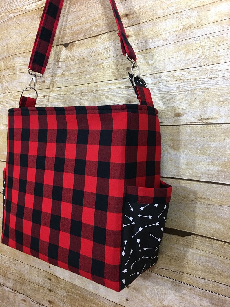 green and black diaper bag