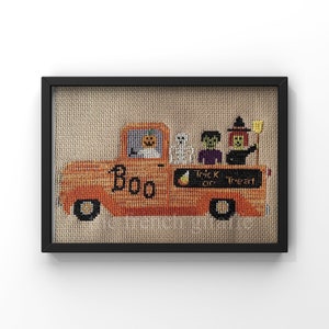 May include: A cross-stitch pattern of an orange pickup truck with a pumpkin on the front, the word "BOO" on the side, and the words "Trick or Treat" on the back. There are four figures in the truck bed: a skeleton, a zombie, a vampire, and a witch.