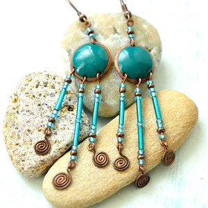 May include: Teal blue and copper dangle earrings with multiple turquoise beads and copper wire spirals.