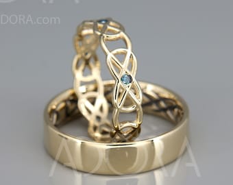 May include: Two gold wedding bands with a Celtic knot design. The top band has a blue gemstone in the center of the knot.