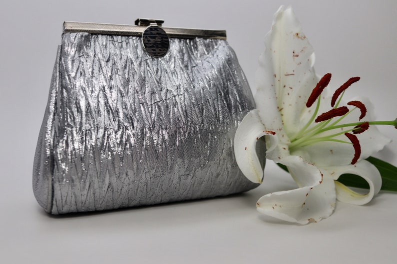 silver evening bag with shoulder strap