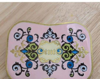 Inlaid enamel brass belt buckle with exceptional detail and logo TNT.