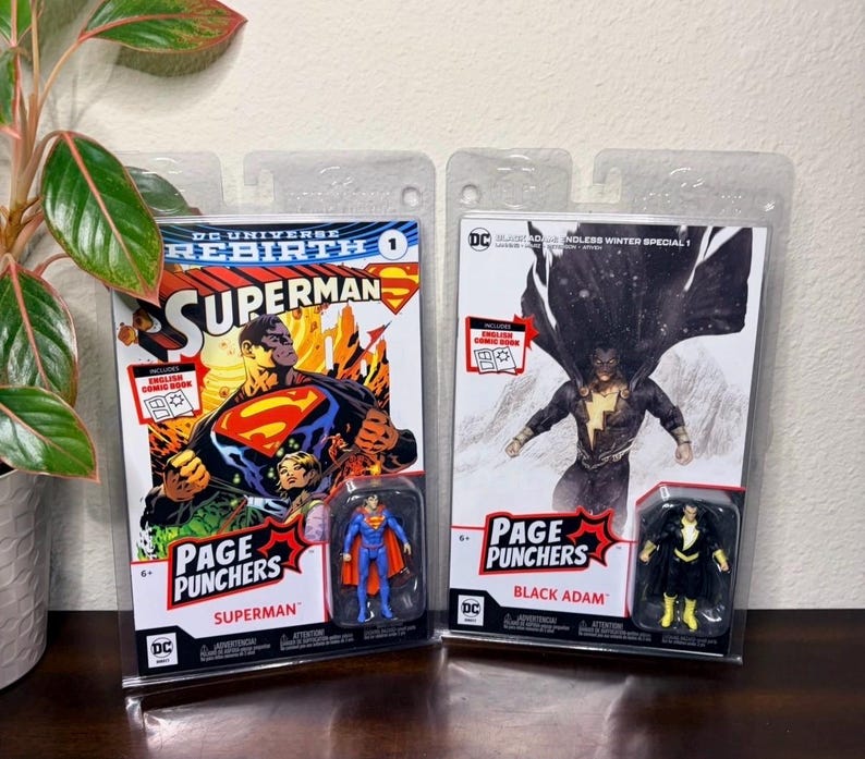 May include: Two Page Punchers action figure sets. One features Superman with a comic book cover, and the other features Black Adam with a comic book cover. Both figures are in clear plastic packaging.