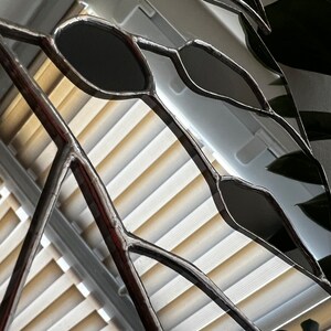 Close-up of mirror glass segments in monstera leaf design