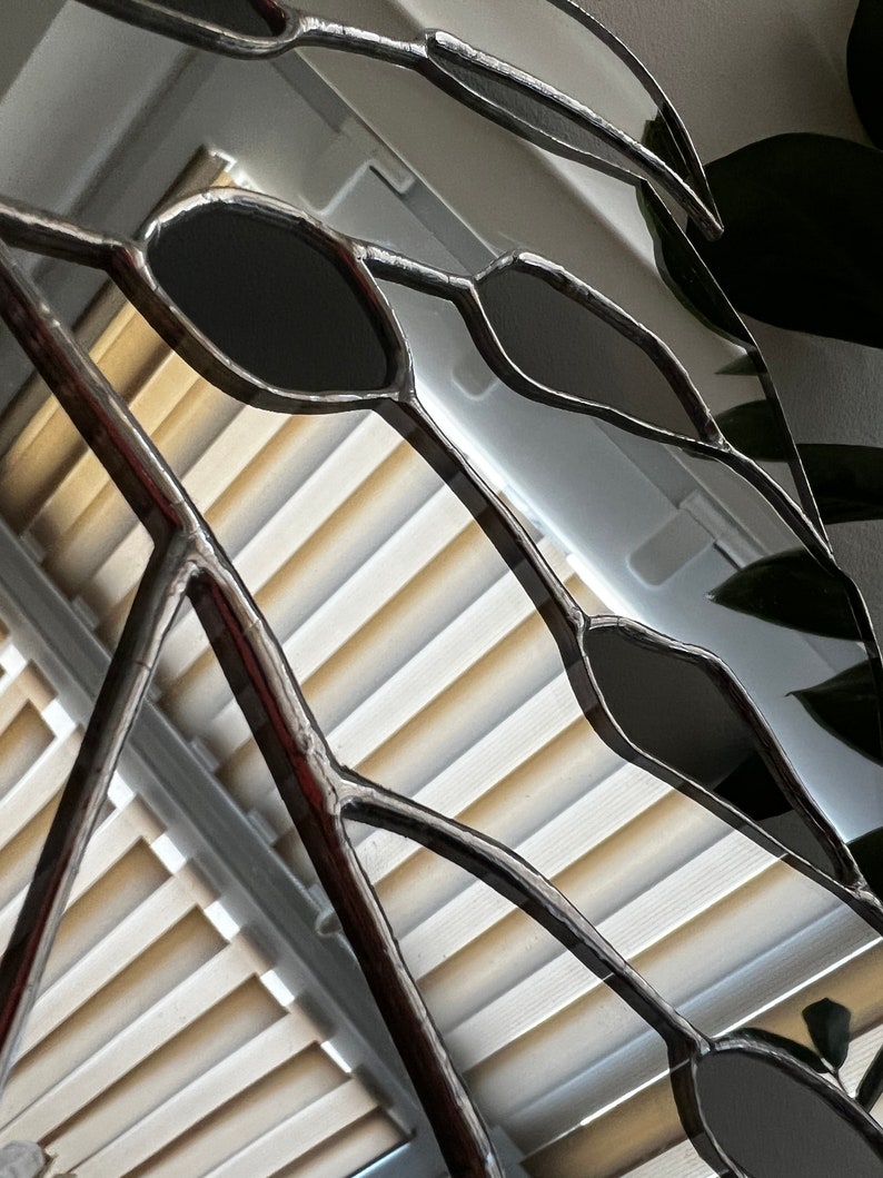 Close-up of mirror glass segments in monstera leaf design