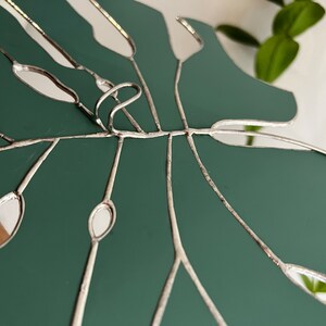 Detailed copper foil lines on stained glass leaf mirror