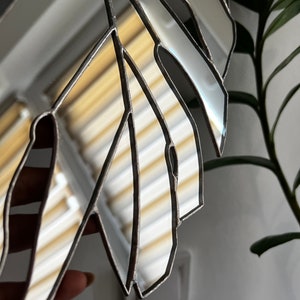 Monstera mirror wall hanging in modern interior