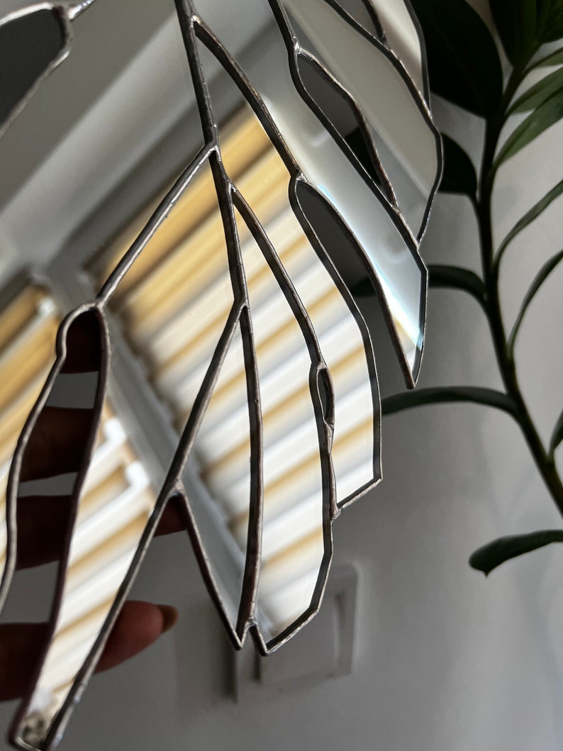 Monstera mirror wall hanging in modern interior