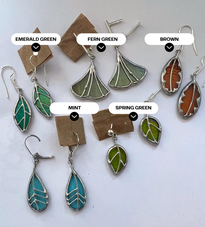 May include: Assortment of stained glass earrings featuring leaf and ginkgo designs in various colours, including emerald green, fern green, brown, mint, spring green, and turquoise.