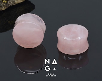 May include: Two pink rose quartz ear gauges, one is a plug and the other is a tunnel. The gauges are made of natural stone and have a smooth, polished finish.