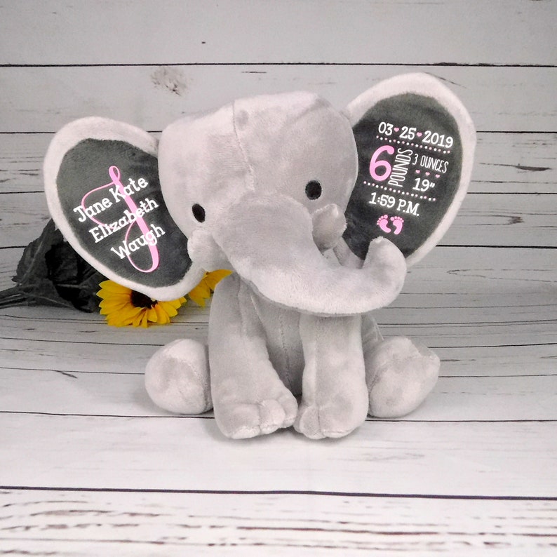 May include: Gray plush elephant with embroidered ears. One ear says "June Kate Elizabeth Waugh" and the other ear says "03-25-2019 6 pounds 3 ounces 19" 1:59 P.M."
