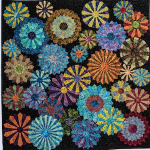 May include: A quilt made of colorful fabric squares, each featuring a different design. The squares are arranged in a circular pattern, creating a visually appealing and intricate design. The quilt is made with a variety of fabrics, including floral prints, geometric patterns, and solid colors.