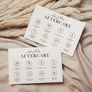 May include: Two white cards with the text "lip filler AFTERCARE" in elegant script. Each card features illustrated icons with instructions, including "Use cold pack for swelling" and "Avoid touching or pressing lips."