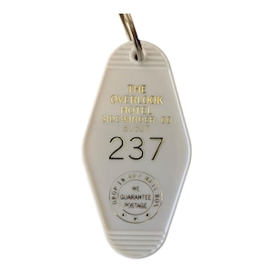 The OVERLOOK HOTEL white block letter and hautned Hotel key tag