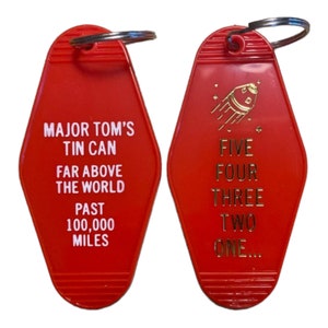 Rock star keytag in red with gold print with lyrics we all know and love about speacemen, (single side)