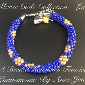 May include: A blue and gold beaded bracelet with a silver clasp and charm. The bracelet is made using the kumihimo technique. The text "Morse Code Collection - Love" is visible at the top of the image. The text "A Beaded Kumihimo Tutorial" is visible at the bottom of the image. The text "Kumi-me-mo By Anne Jones" is visible at the bottom of the image.