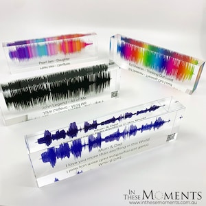 May include: Four clear acrylic blocks with sound wave patterns and text. The blocks feature different colours and song titles, including "Pearl Jam - Daughter", "John Legend - All of Me", "Ed Sheeran - Thinking Out Loud", and "Mum & Dad - I love you more than anything in this world".