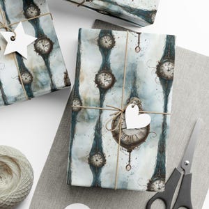 May include: A blue and white wrapping paper with a repeating pattern of antique clocks. The paper is tied with twine and a white heart-shaped tag.