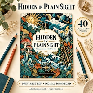 May include: A coloring book titled Hidden in Plain Sight with 40 pages, featuring a cover illustration of a sun, moon, planets, mushrooms, crystals, keys, and a compass. The book is surrounded by colored pencils and decorative elements.