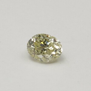 An unmounted Oval-shaped diamond weighing app. 0.68ct. Colour : Yellow  .Clarity SI2